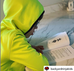 Young ninja reading A Tale Of Two Ninja Kids Book Young ninja reading A Tale Of Two Ninja Kids Book