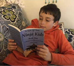 Happy reader with A Tale Of Two Ninja Kids Book Happy reader with A Tale Of Two Ninja Kids Book