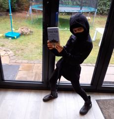 Young ninja holding "A Tale Of Two Ninja Kids" book. Young ninja holding "A Tale Of Two Ninja Kids" book.